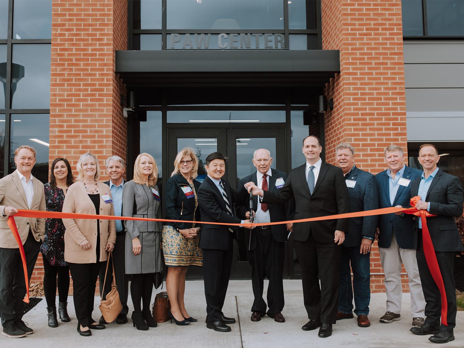 Ribbon cutting in front of the PAW Center building at Penn State DuBois