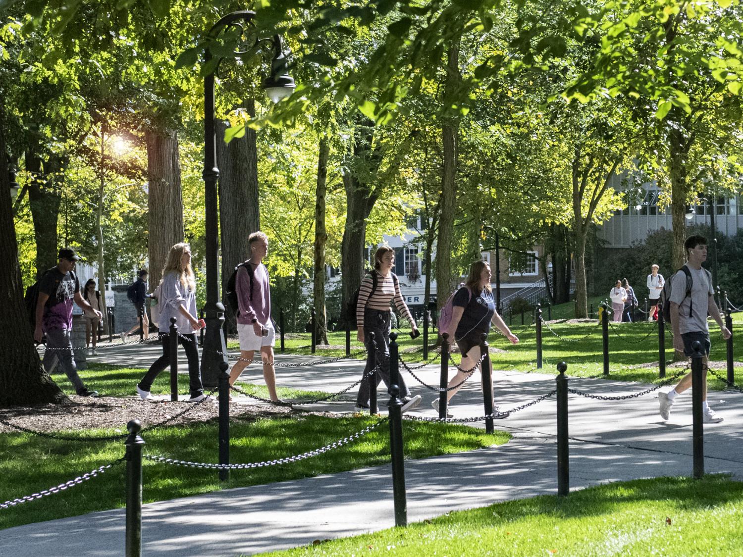 Students walking on campus on a sunny day.