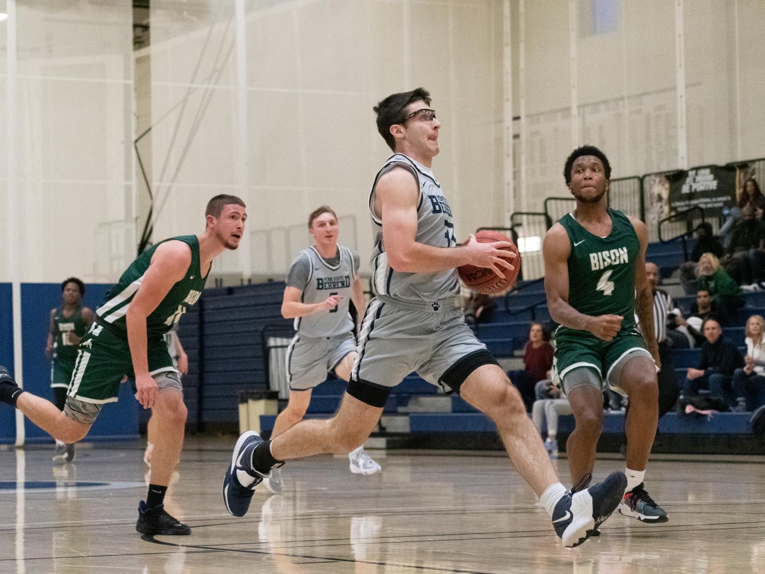 A Penn State Behrend basketball player prepares to take a layup.