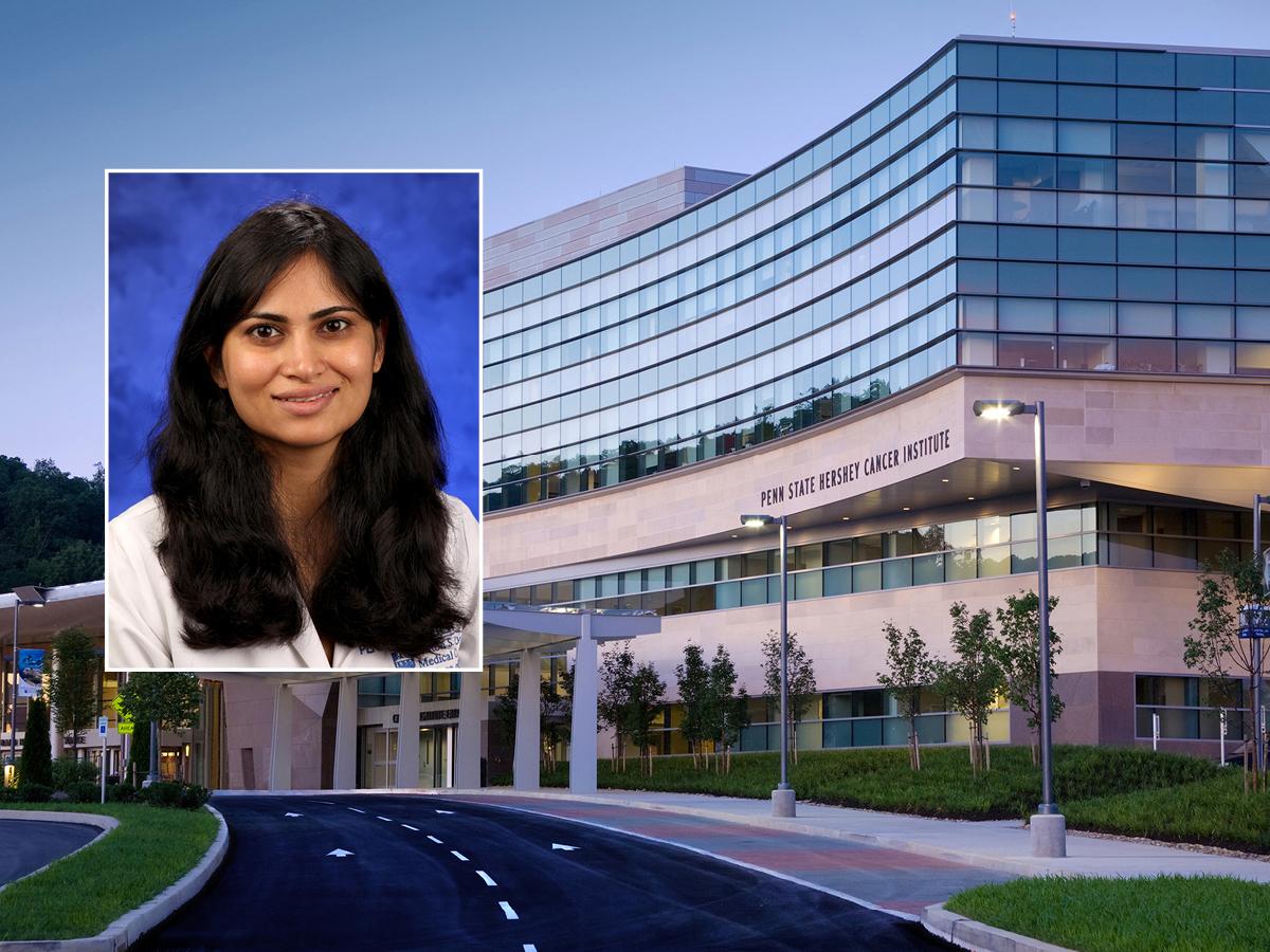 A head and shoulders professional portrait of Dr. Monali Vasekar against a background image of Penn State Cancer Institute. 