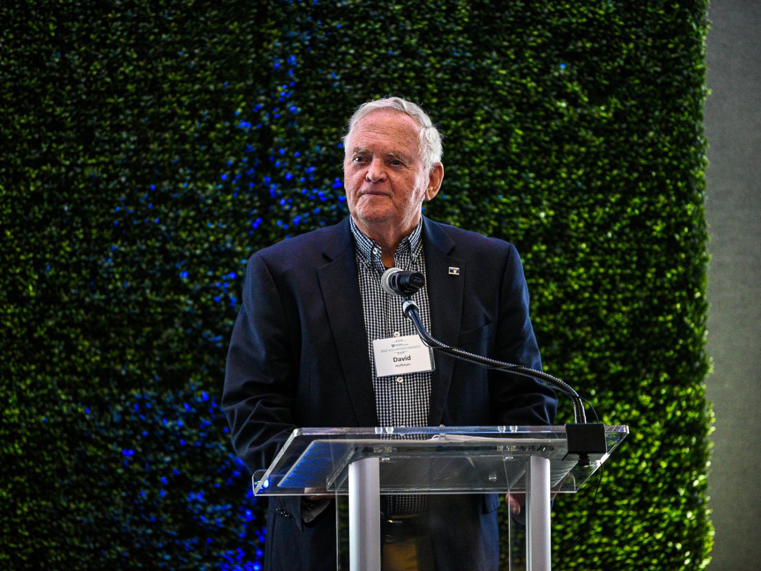 Man standing at podium to accept award