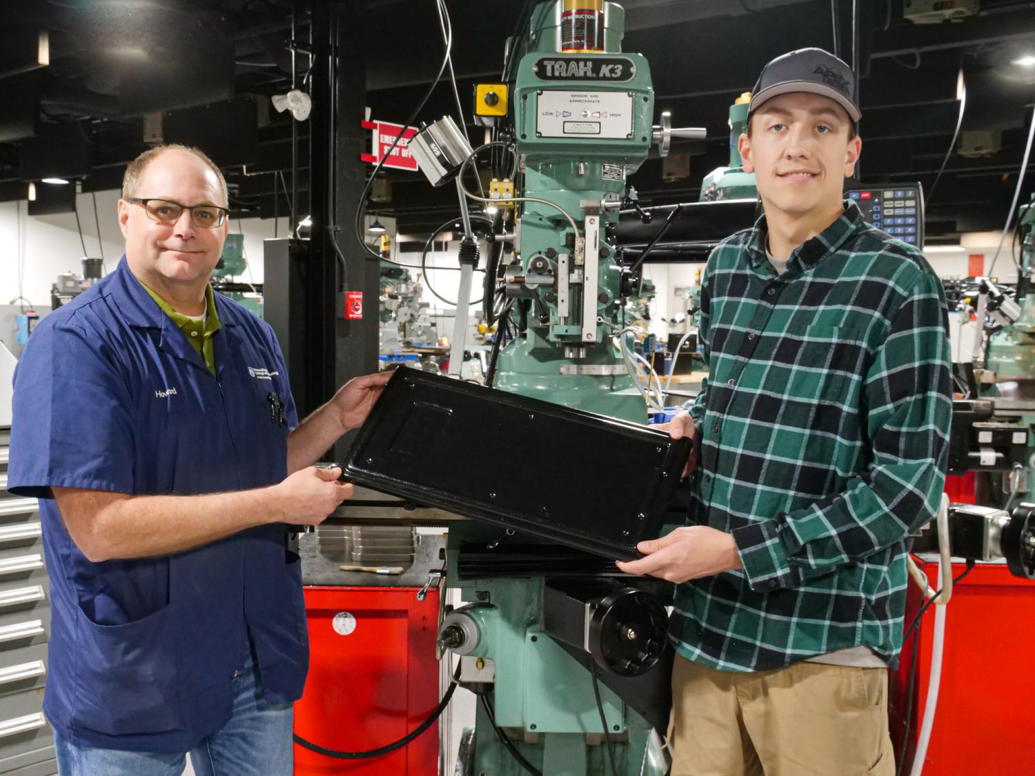 Penn College instructor with student who designed a plastics mold.