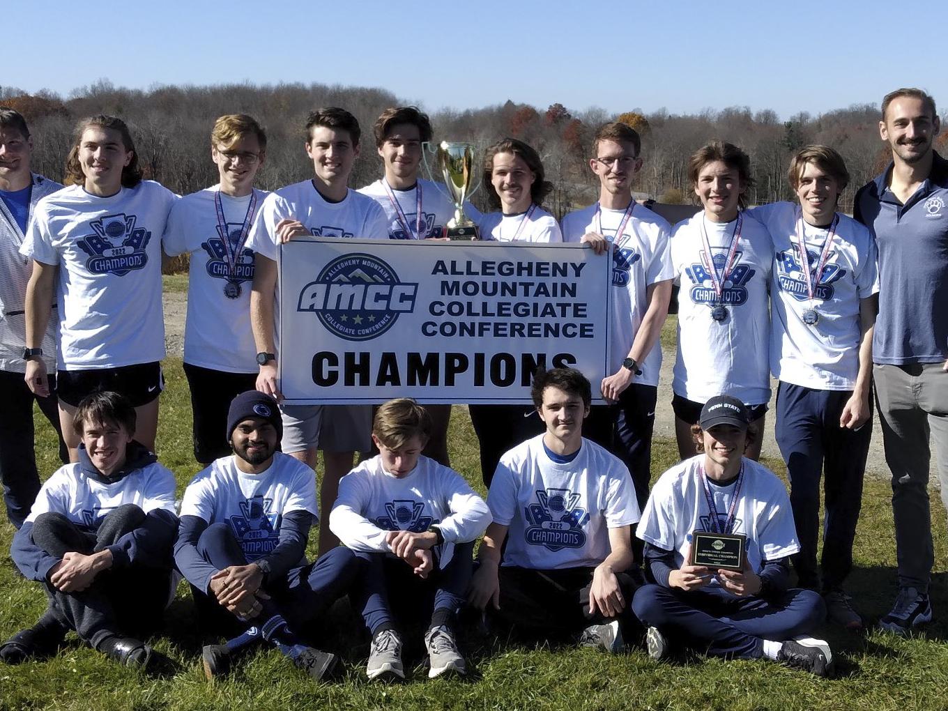 A group photo of the Penn State Behrend men's cross country team with an AMCC championship banner.