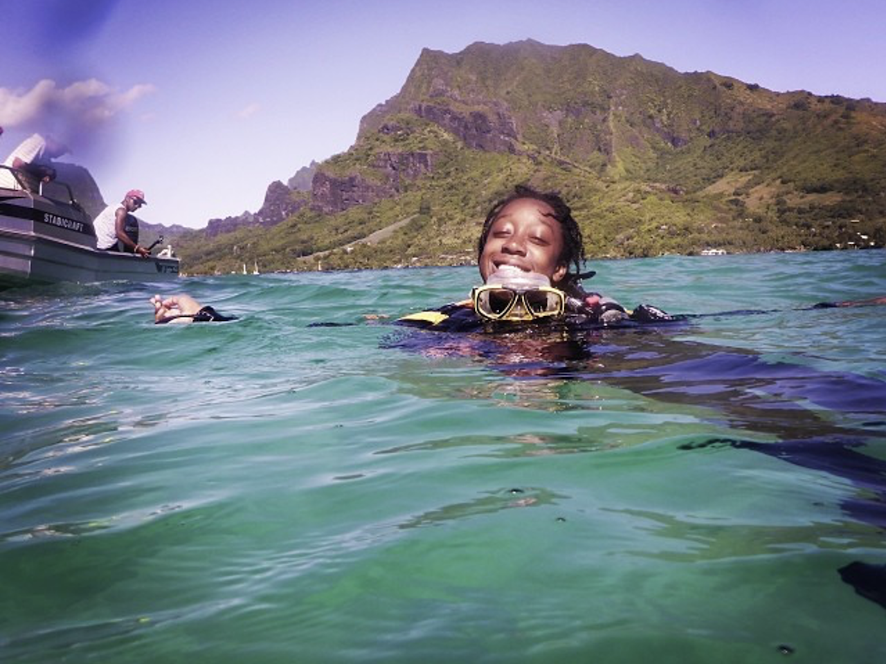 Camille smiling in the ocean wearing scuba gear