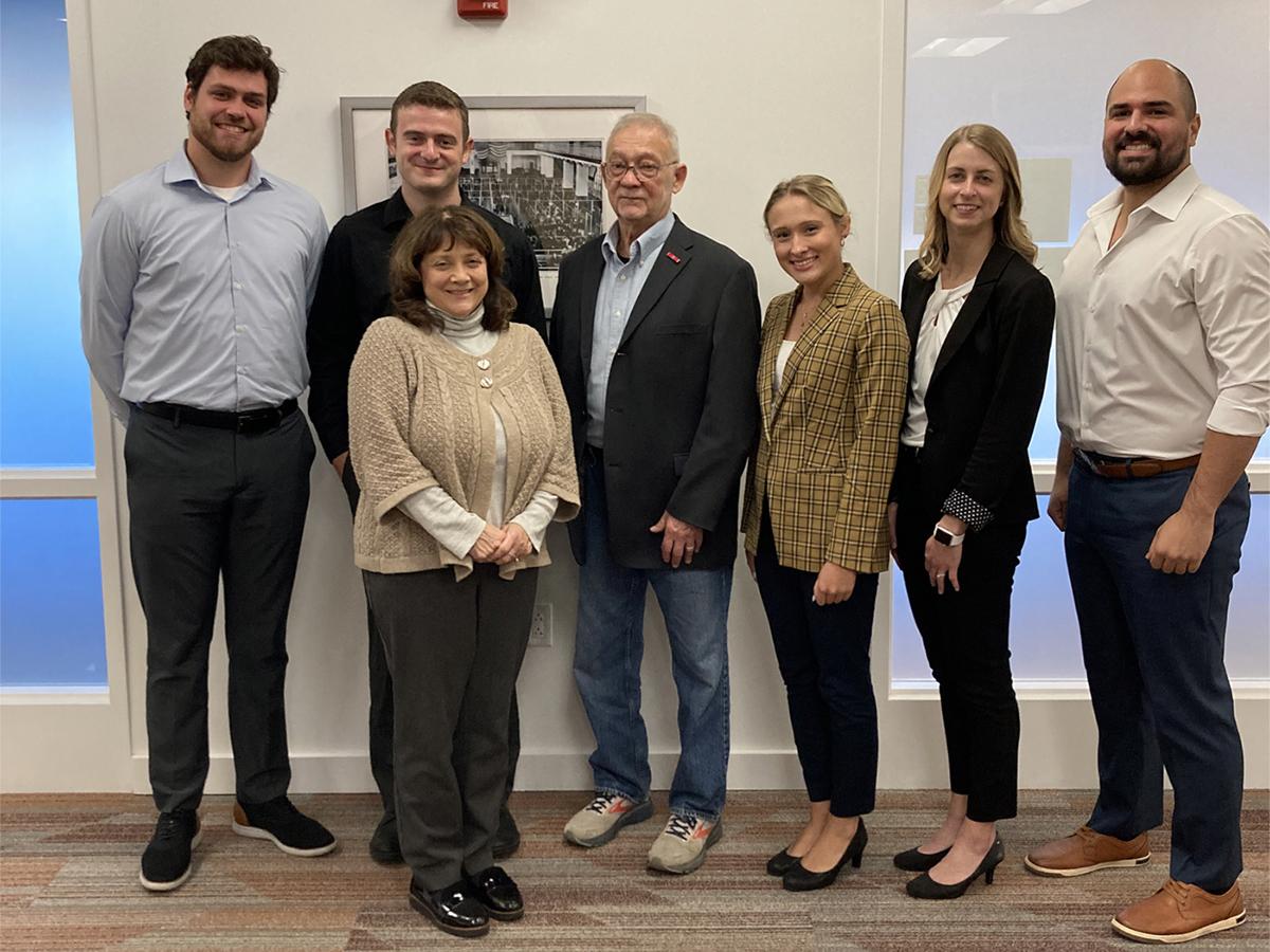 Michele Vollmer next to Clinic students and Clinic veteran client