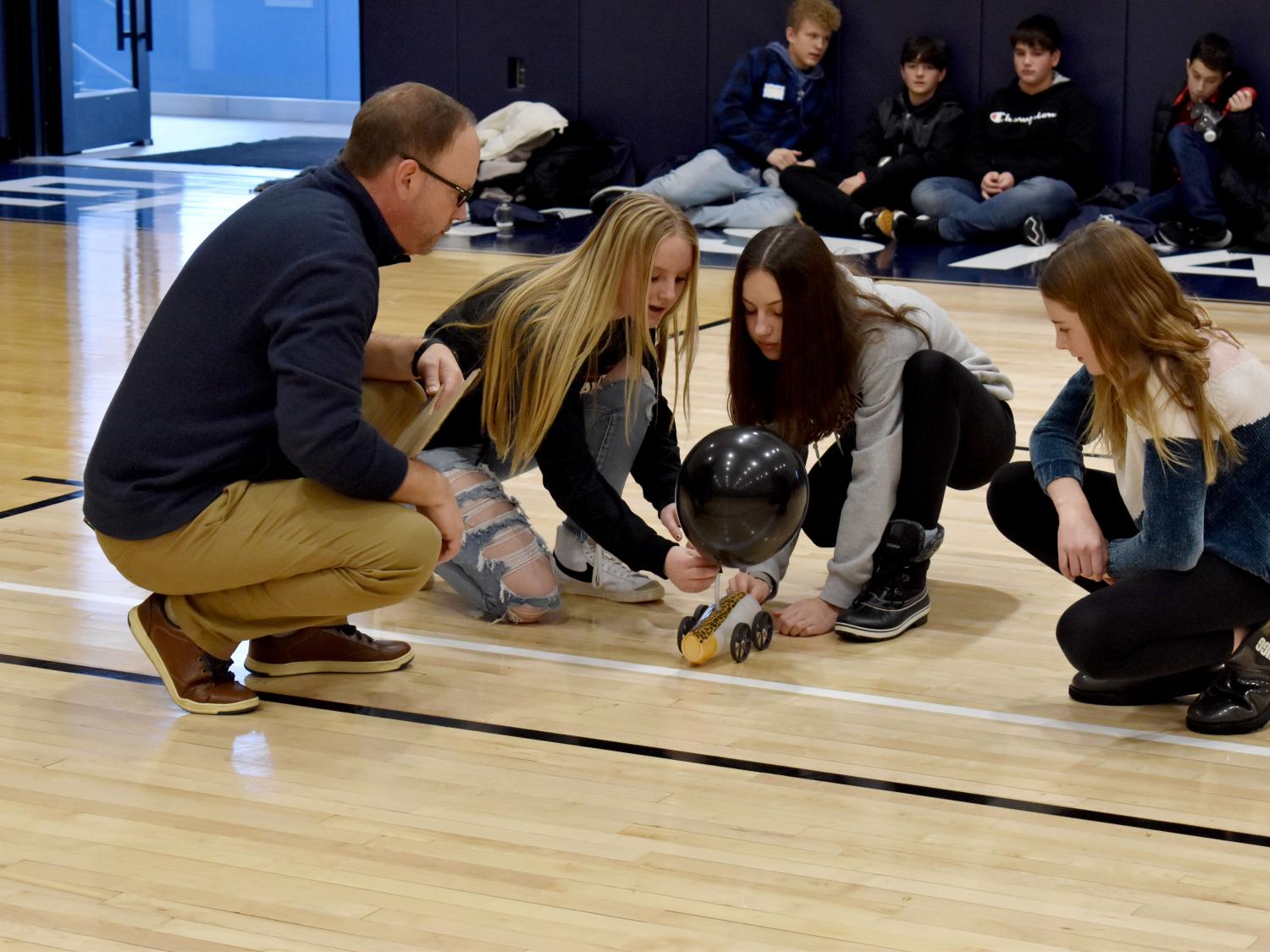 Students prepare to start their vehicle in the distance race at the PAW Center during STEAM Day at Penn State DuBois, under the guidance of Brad Lashinsky, program director for the North Central PA LaunchBox powered by Penn State DuBois