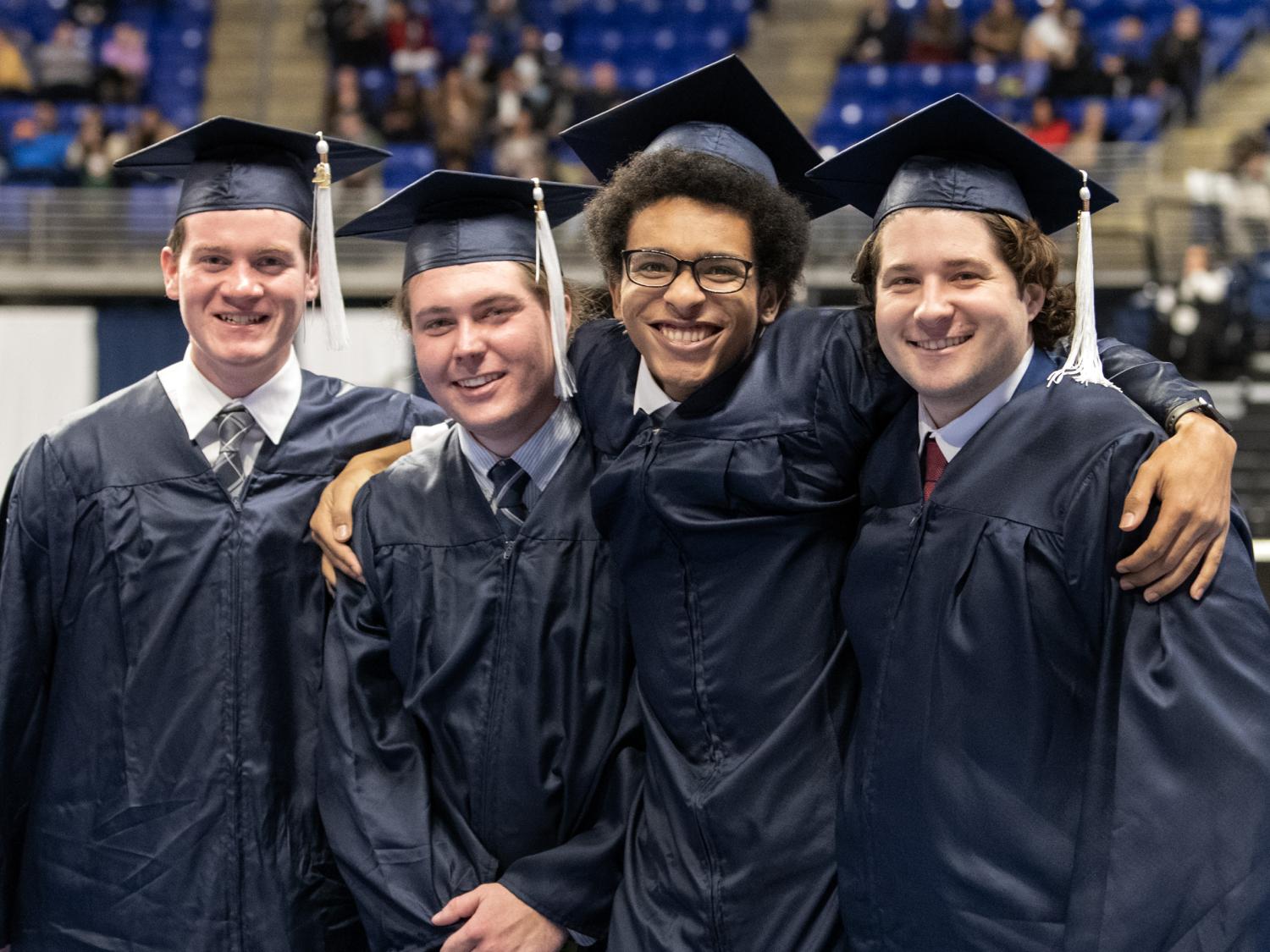 graduates pose for a photo at the Bryce Jordan Center