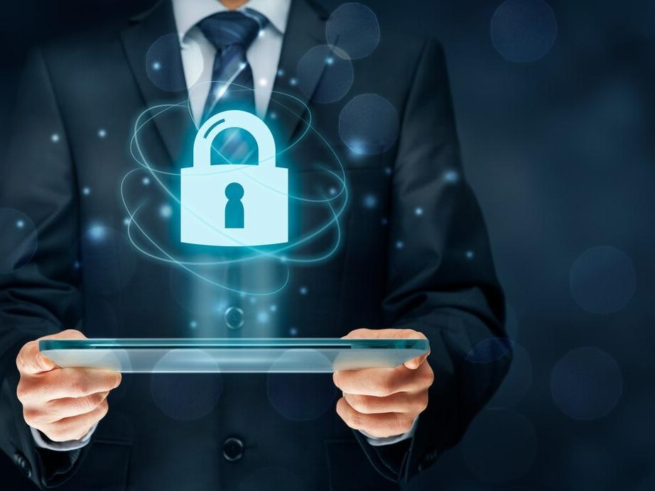 An illustration of an office worker holding a secure laptop.