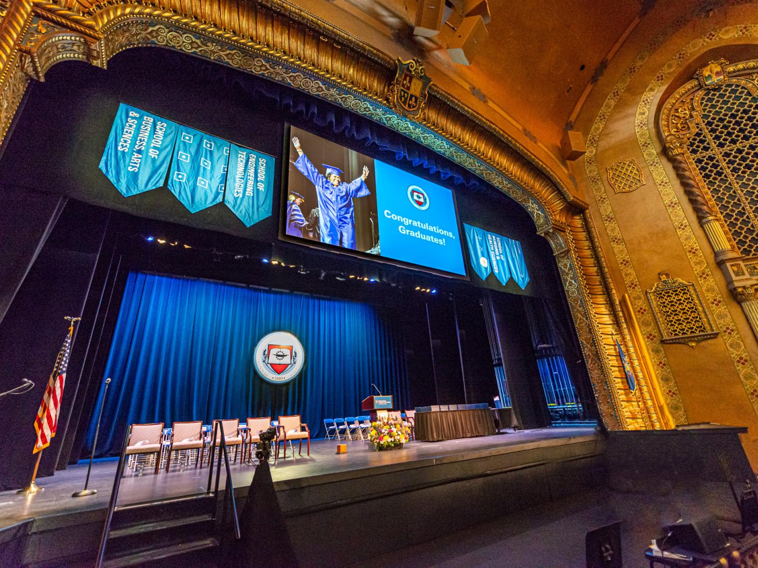 An auditorium decked out in festive blues for a graduate ceremony