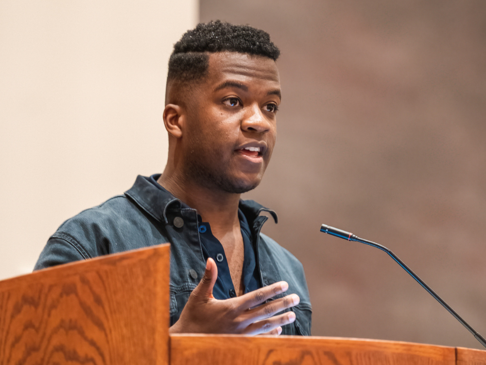 Penn State student Michael Mitole reads his essay at the podium in the Pasquerilla Spiritual Center at the Paterno Fellows Recognition Ceremony on April 18, 2022.
