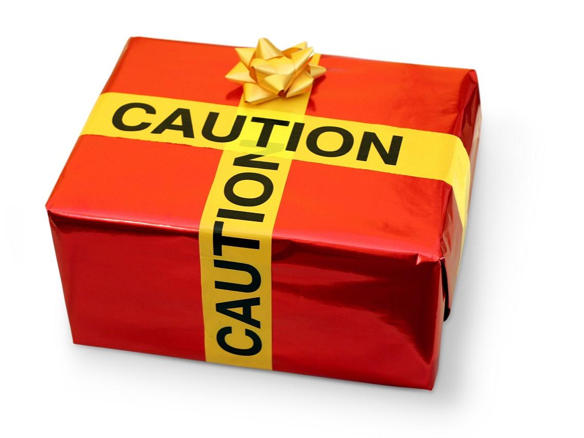 A holiday gift is wrapped with paper and caution tape.