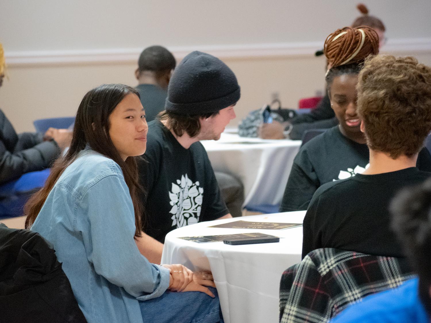 Students sit at tables during the anniversary celebration for the Multicultural Academic Excellence Program.