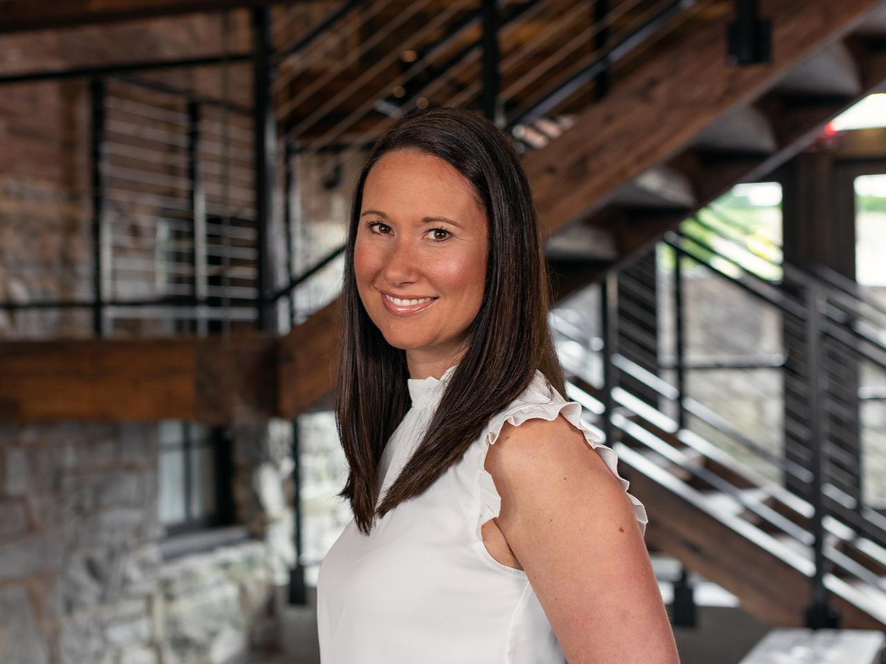 Aliana Steinbugl wearing white with stairs in the background