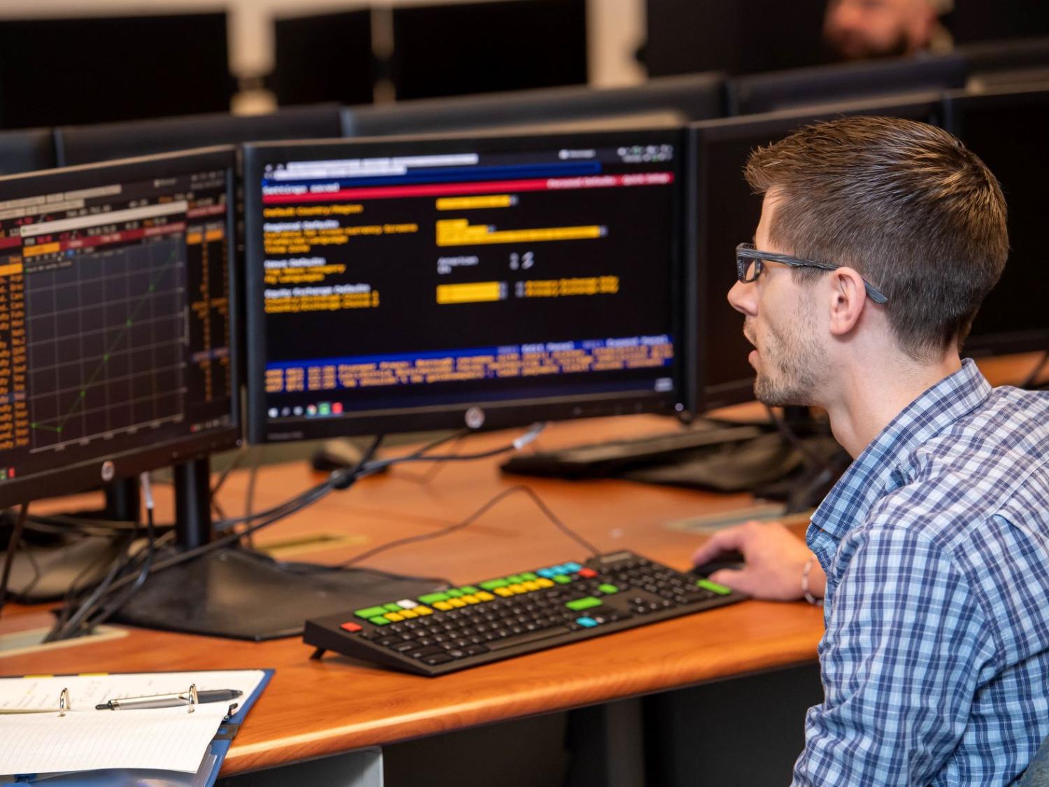 A student in Penn State Behrend's Black School of Business tracks a stock's performance on a Bloomberg Terminal.
