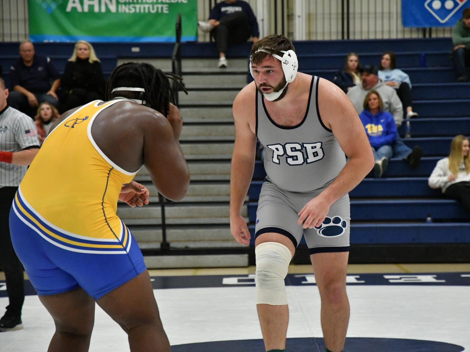 Penn State Behrend wrestler Kyle Trim faces off against an opponent.
