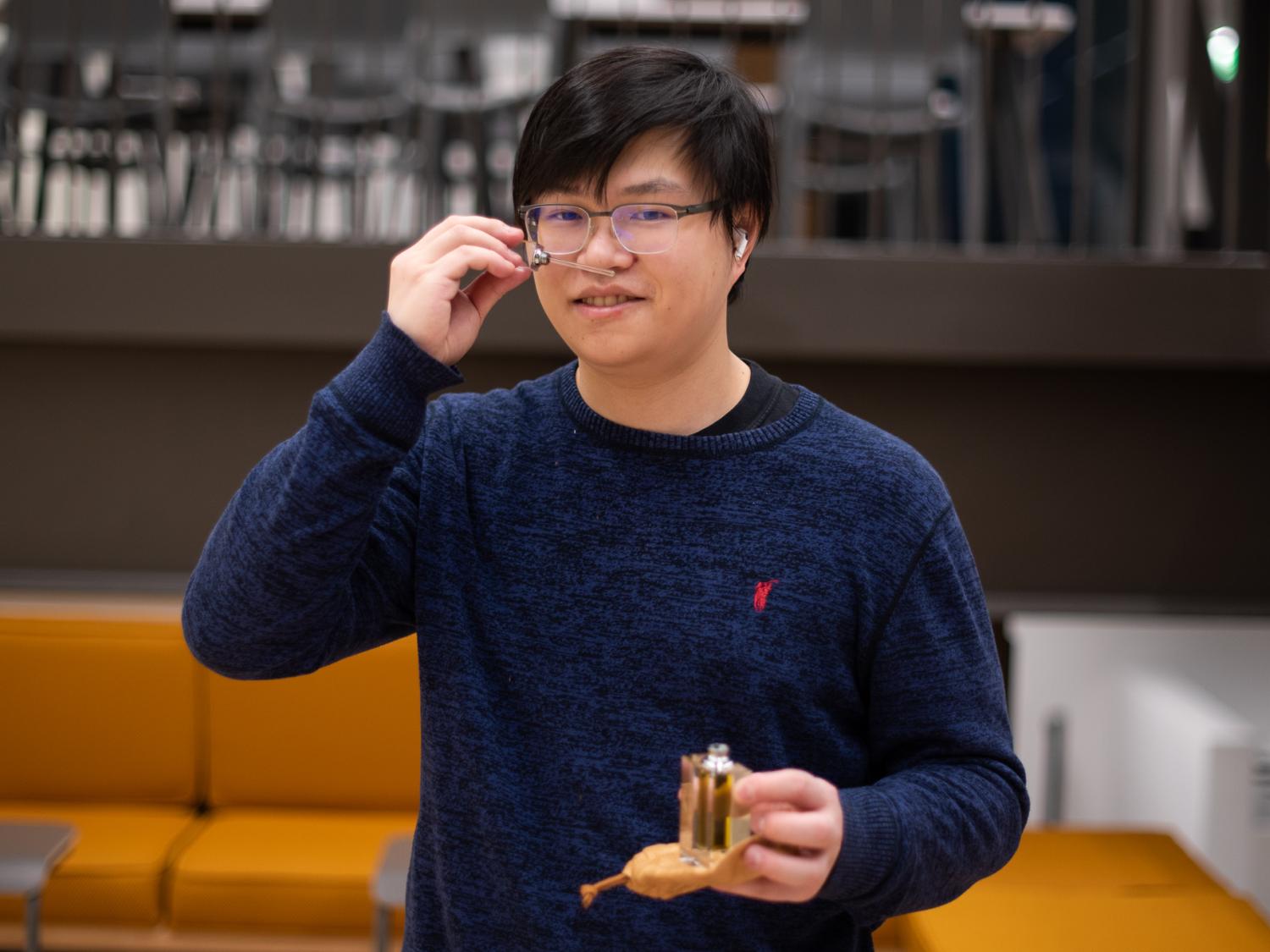 Tianyou Lou shows off one of the fragrances he created for his company, Mobius Fragrances