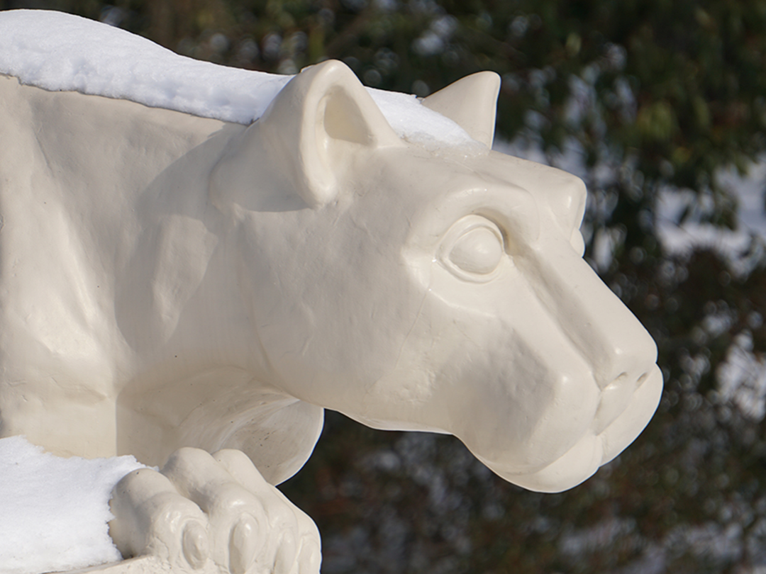 Statue of Nittany Lion coated in snow.