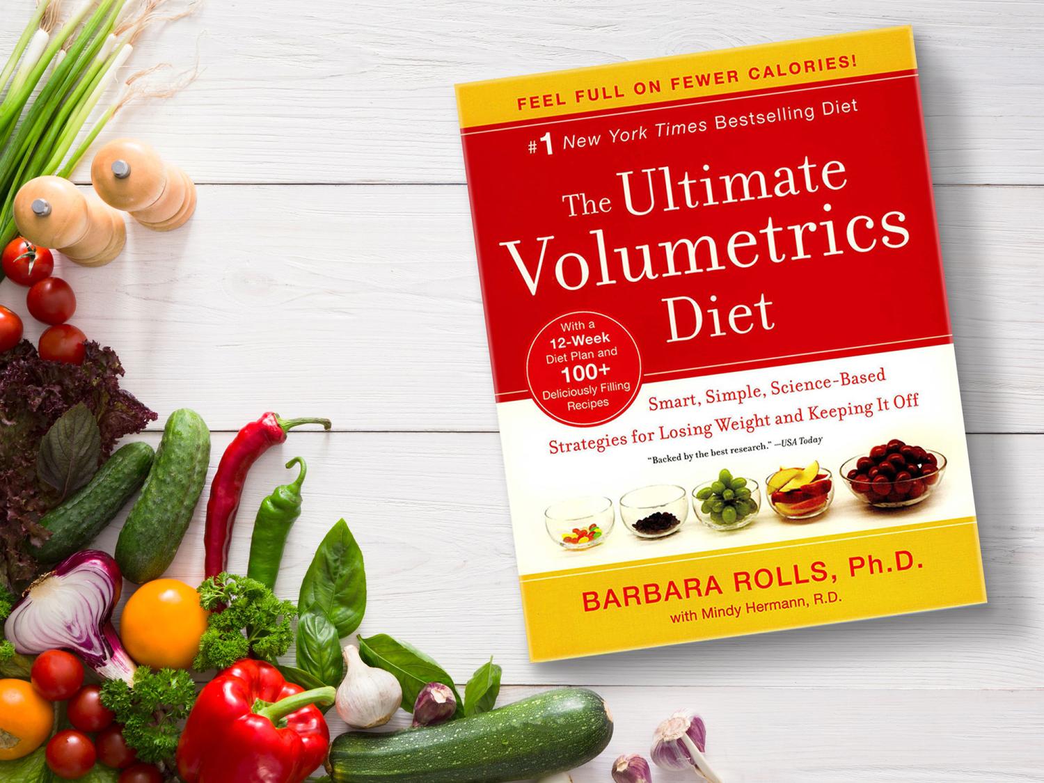 The book 'Ultimate Volumetrics' on a white background with many vegetables around