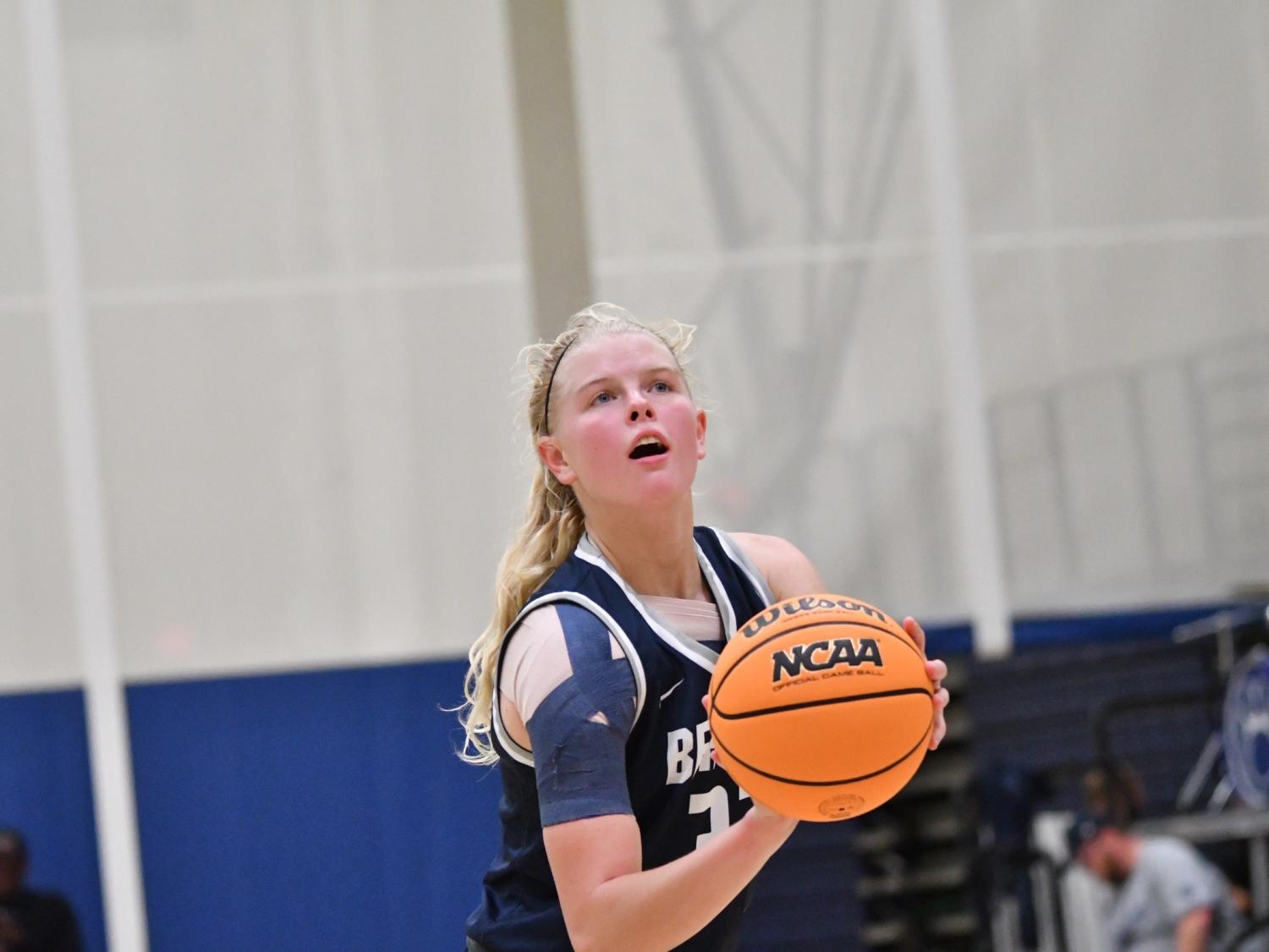 A member of the Penn State Behrend basketball team prepares to shoot the ball.