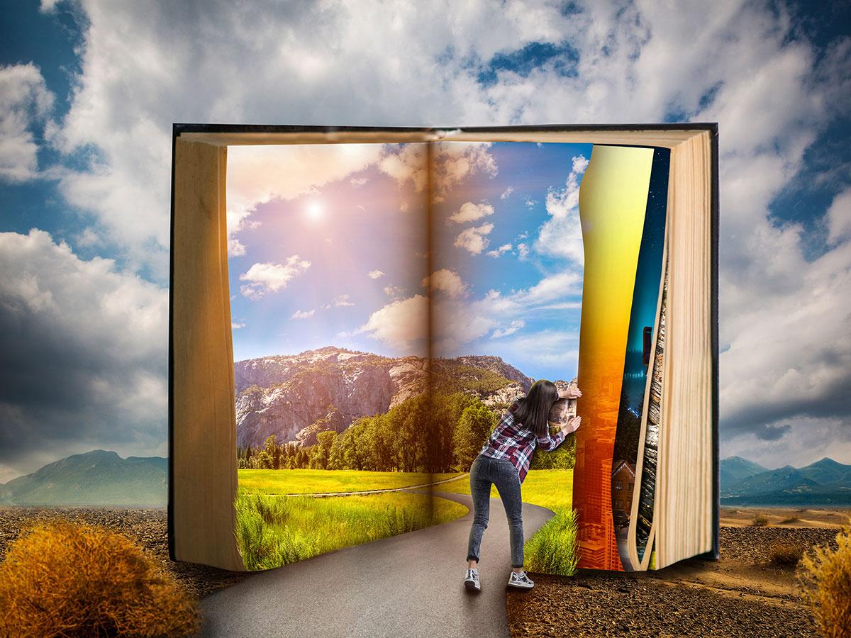 Image of a female turning the pages of an enormous book