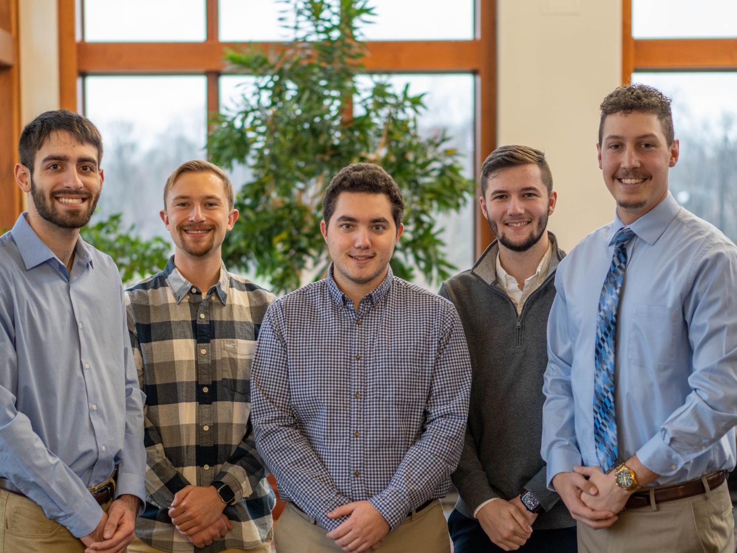 Five Penn State Behrend students pose in Metzgar Center.