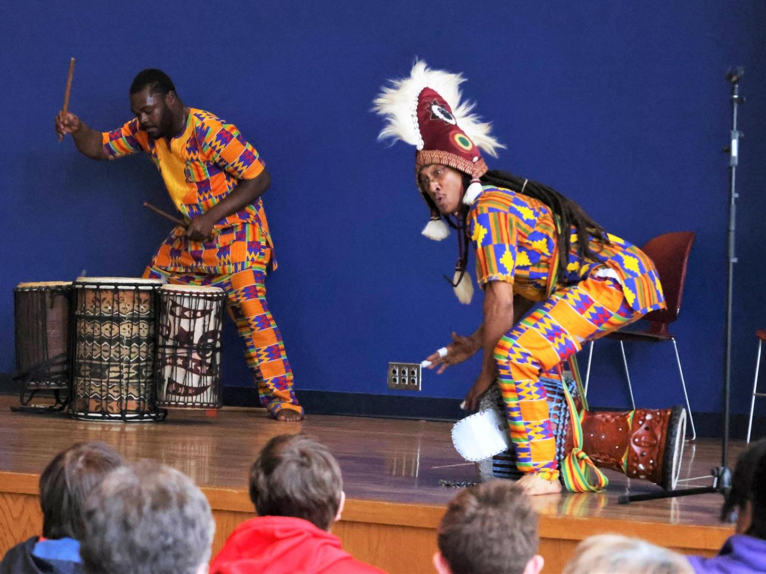 Two drummers perform traditional African music on a stage at Penn State Behrend's McGarvey Commons.