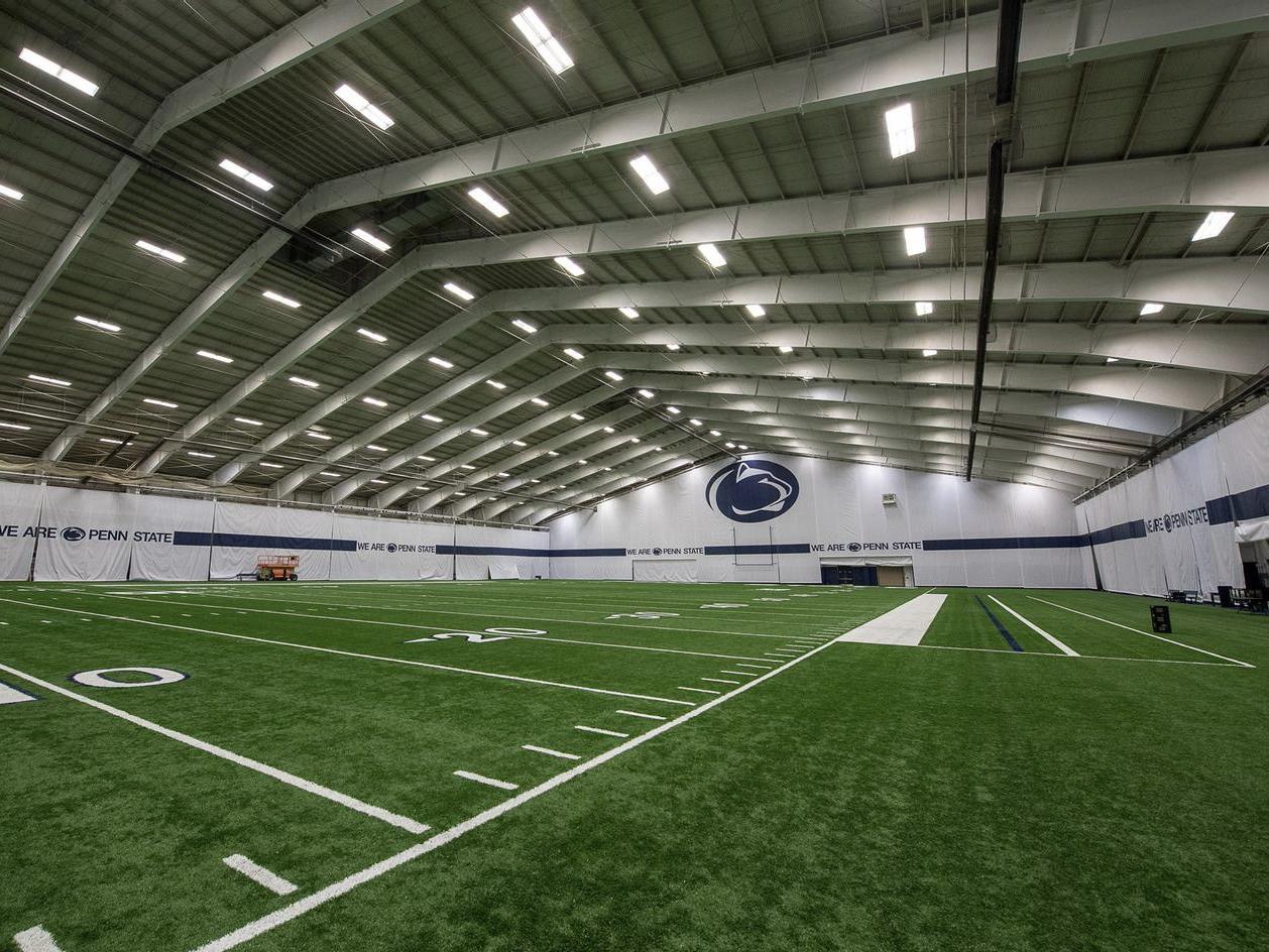 An interior view of an indoor football practice facility.