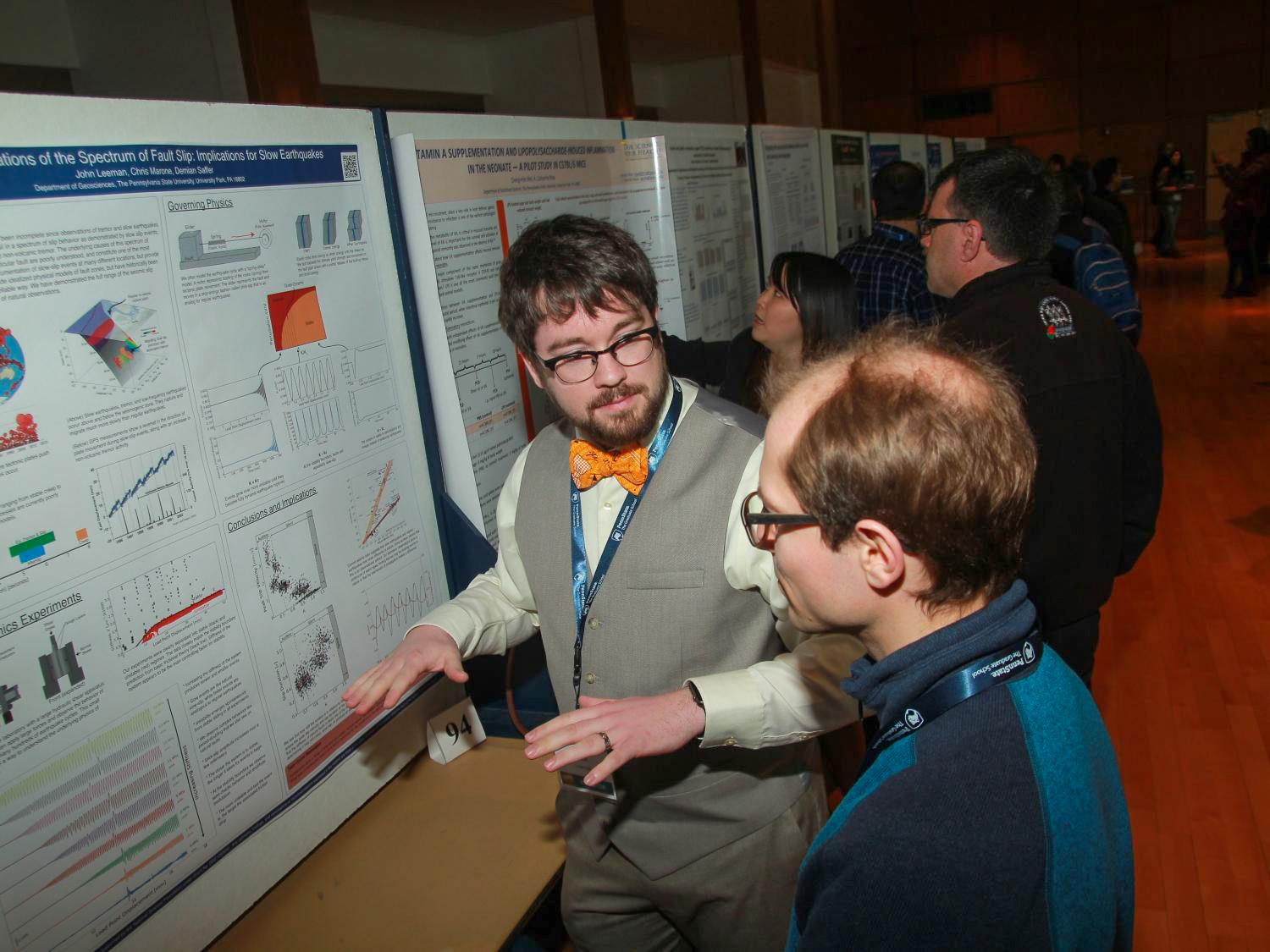 student presenting work at Graduate Exhibition