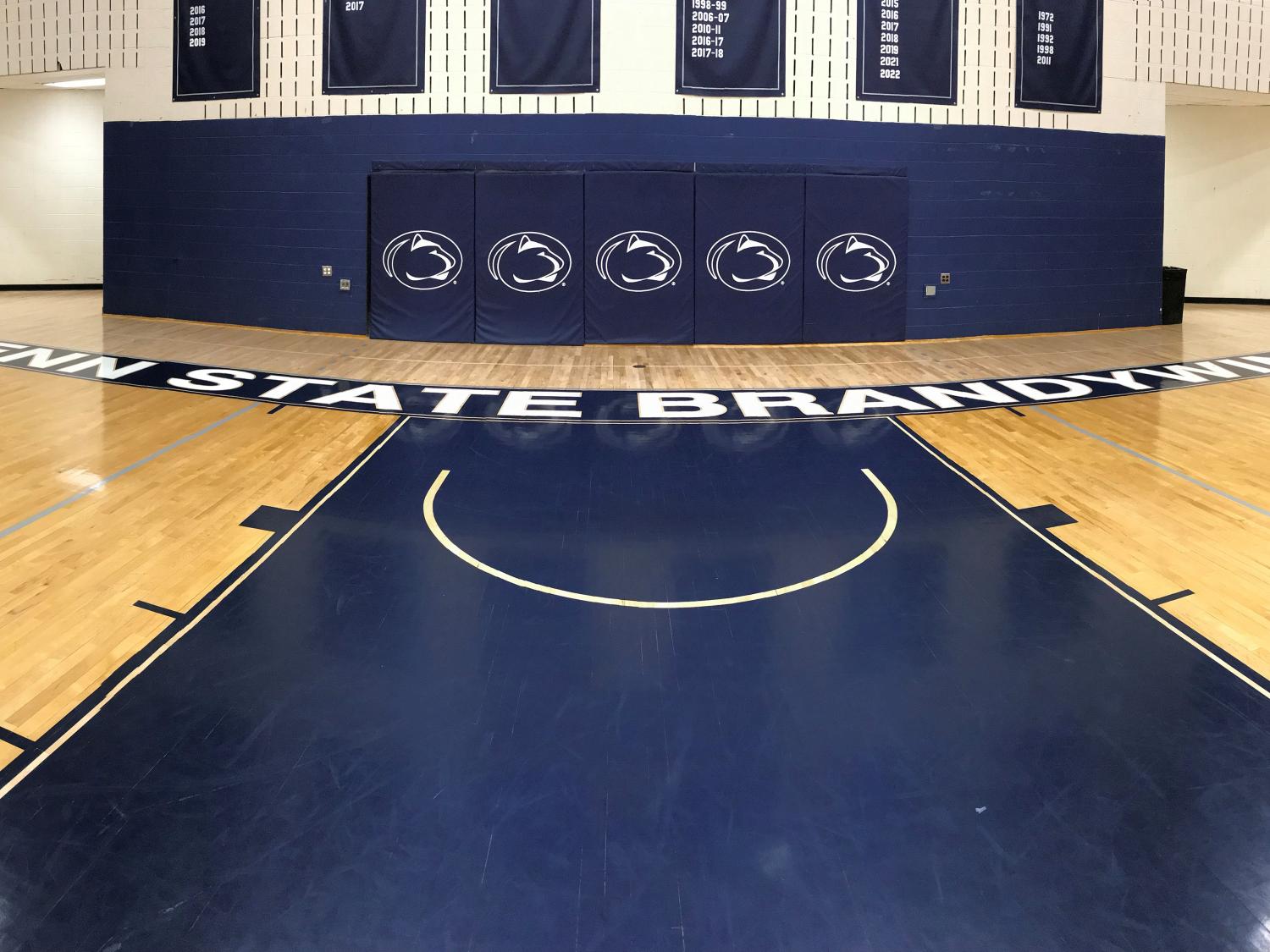 Penn State Brandywine gym floor showing Penn State athletics logos.