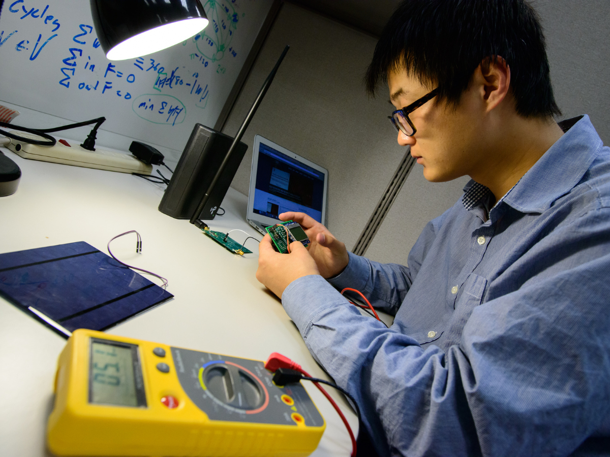 A researcher at Penn State working on electronics development at a desk