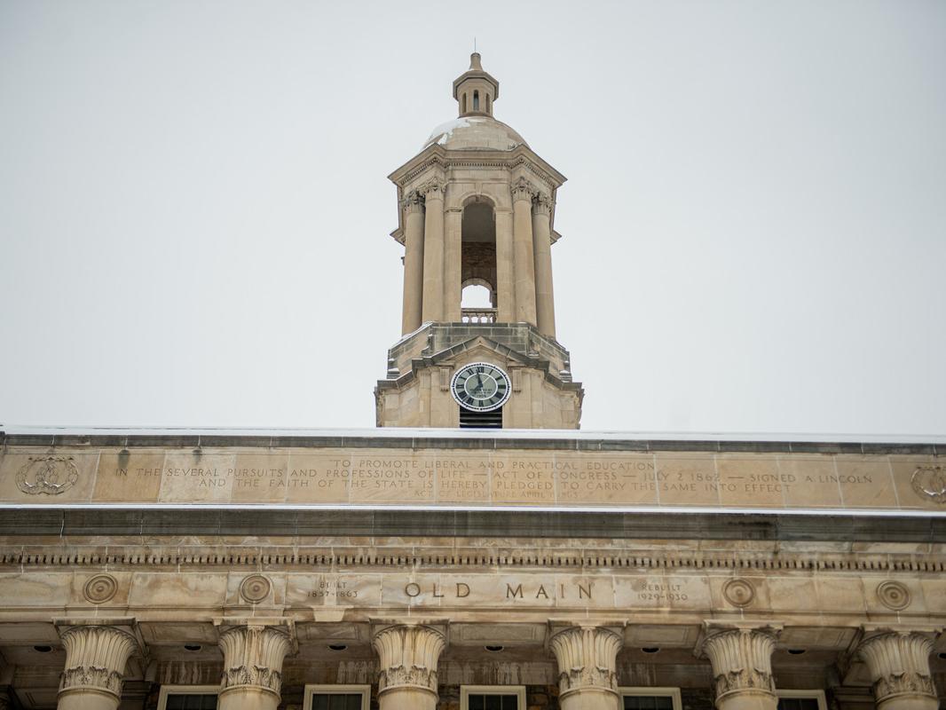 Tower of campus building with grey skies in background.