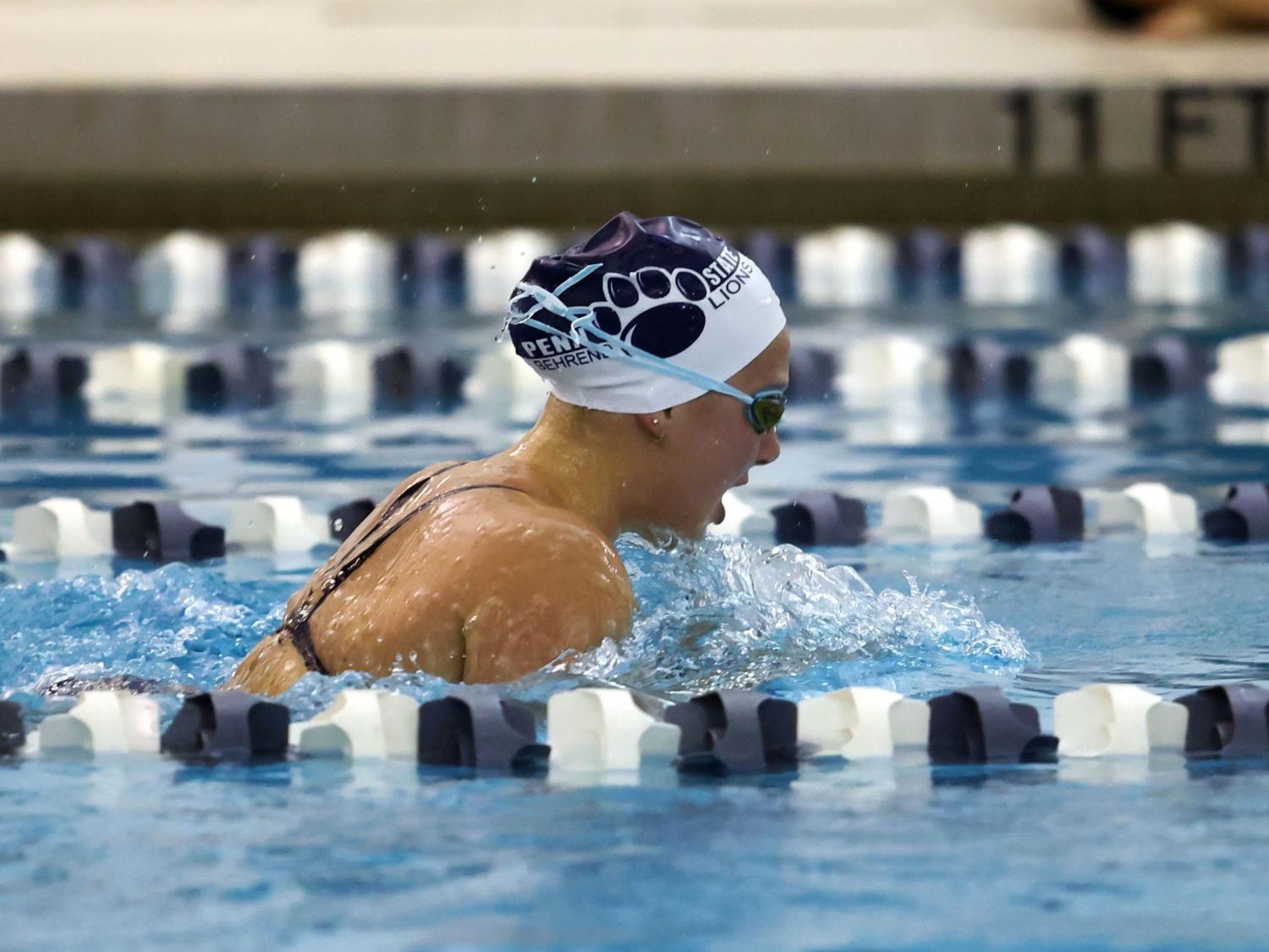 A female Penn State Behrend swimmer competes in a breaststroke race.
