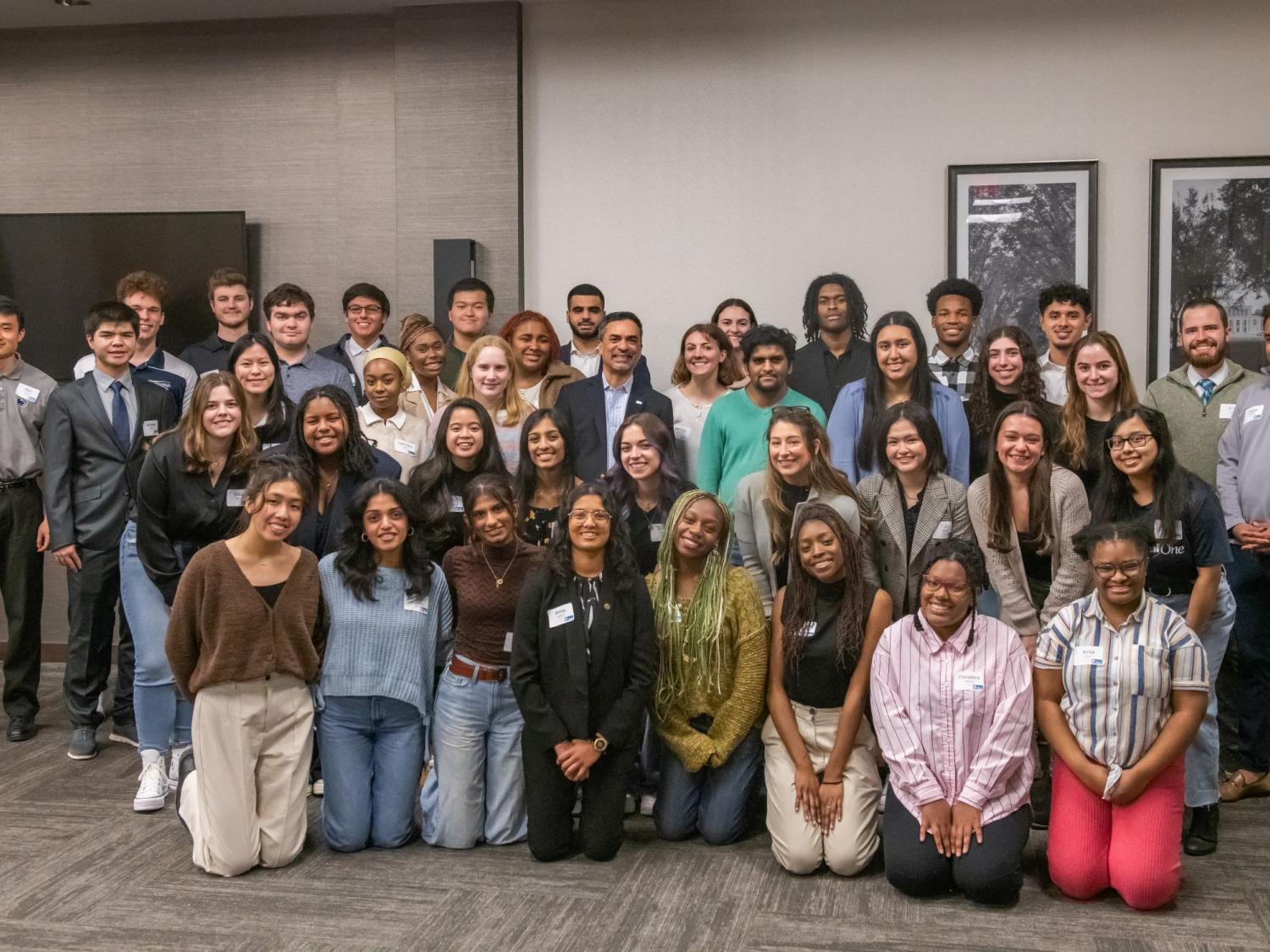 A large group of students in professional dress posing for a photo