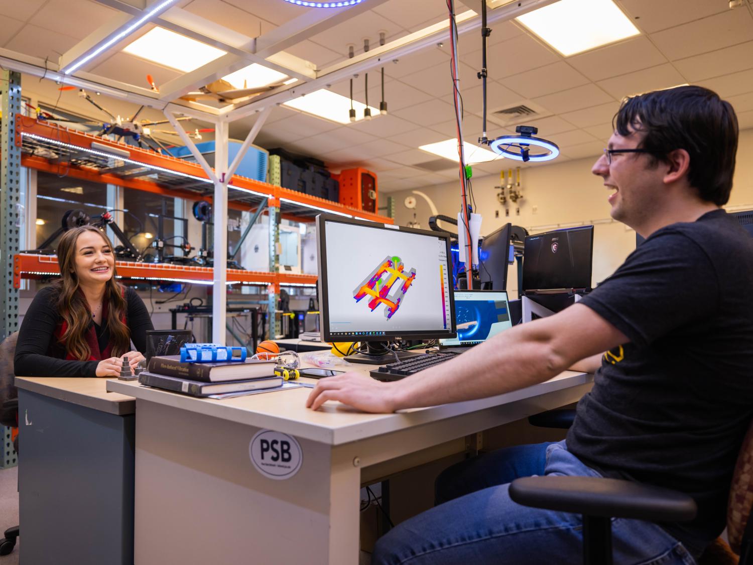 Two students work at a computer station in the Meehl Innovation Commons at Penn State Behrend.
