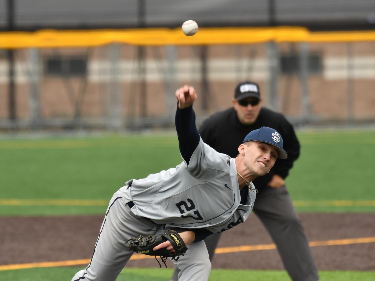 A pitcher for the Penn State Behrend baseball team throws the ball.