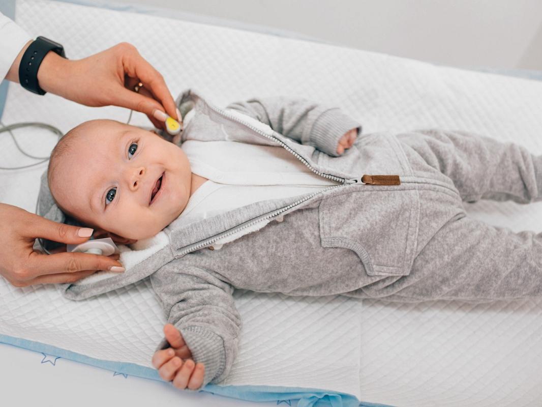 A baby receives a hearing test.