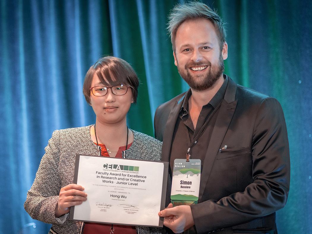 Hong Wu, at left, accepts her 2023 Excellence in Research and/or Creative Work Award from Simon M. Bussiere, second vice president of the Council of Educators in Landscape Architecture.
