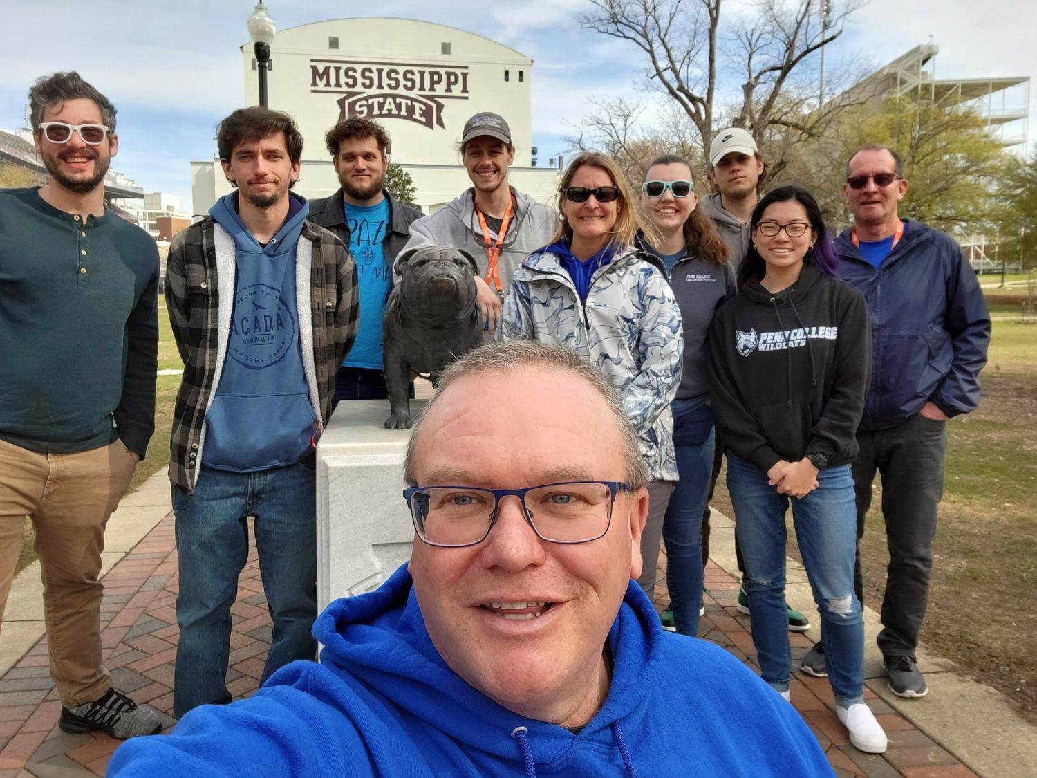 Group photo of Penn College students and teacher at a competition.