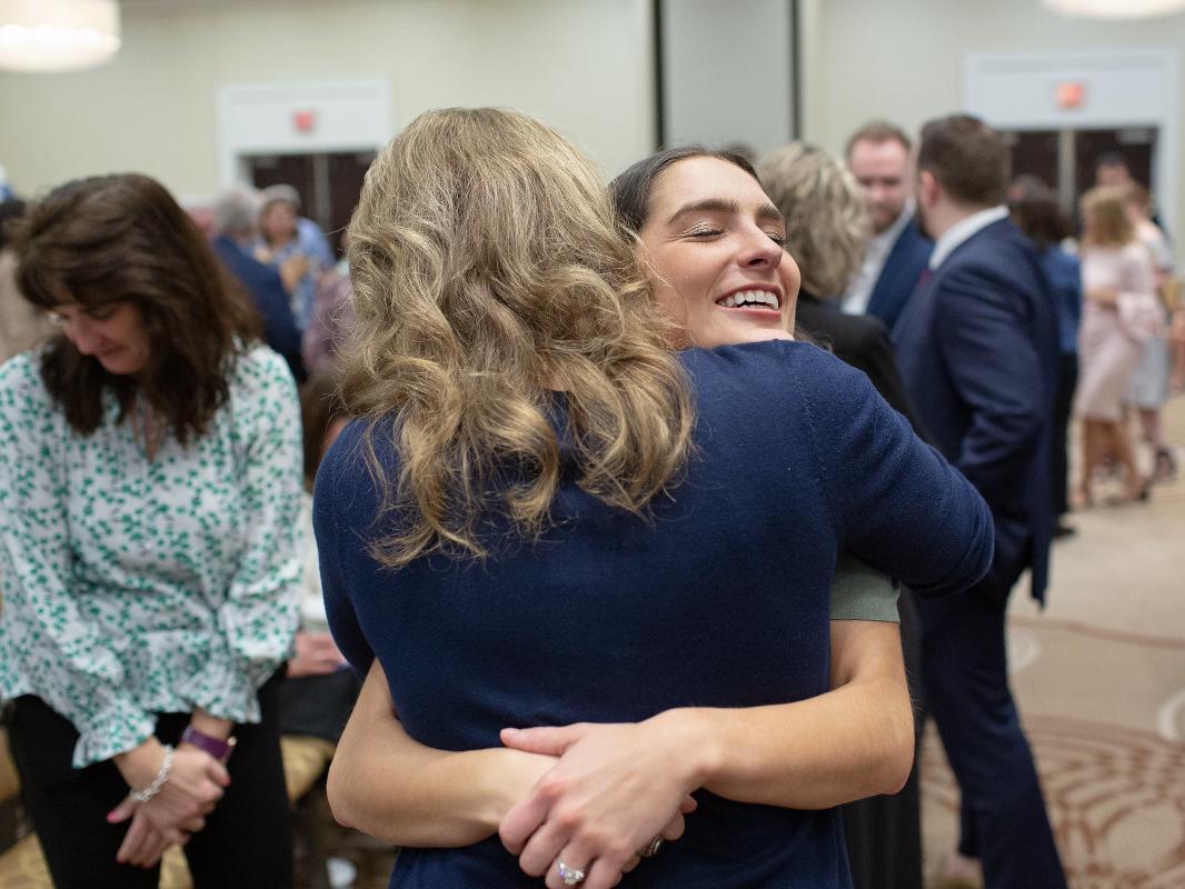 Two women embrace