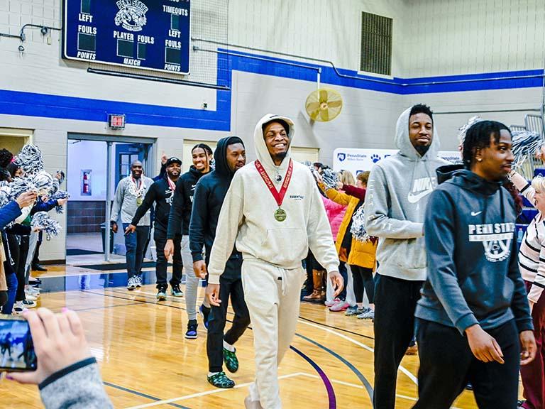 Team members walking into the gymnasium
