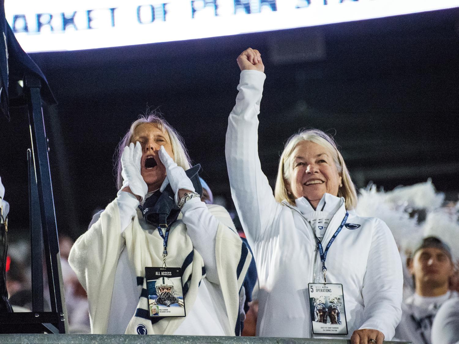 Two women cheering at a football game
