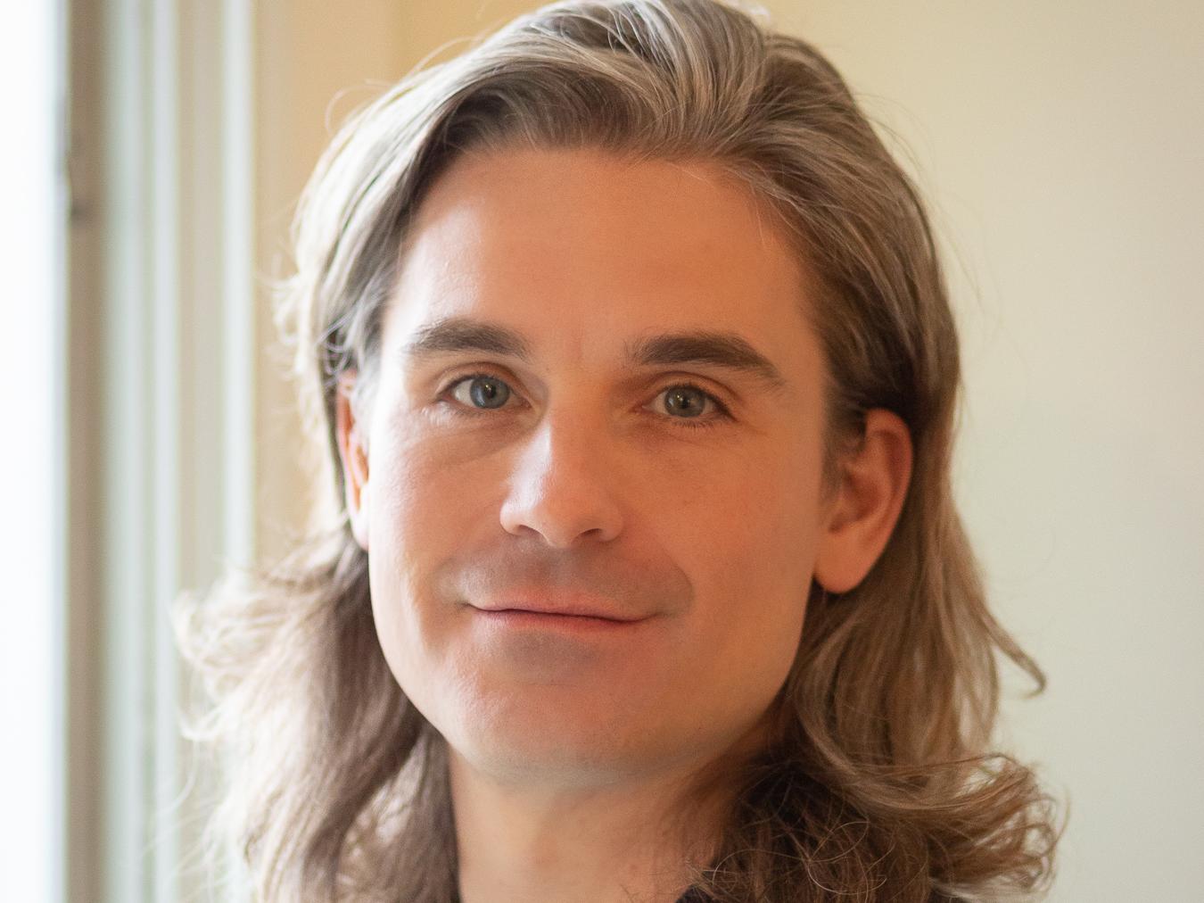 A headshot of John Eicher