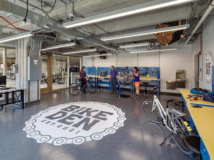 Bike Den volunteers assist visitor