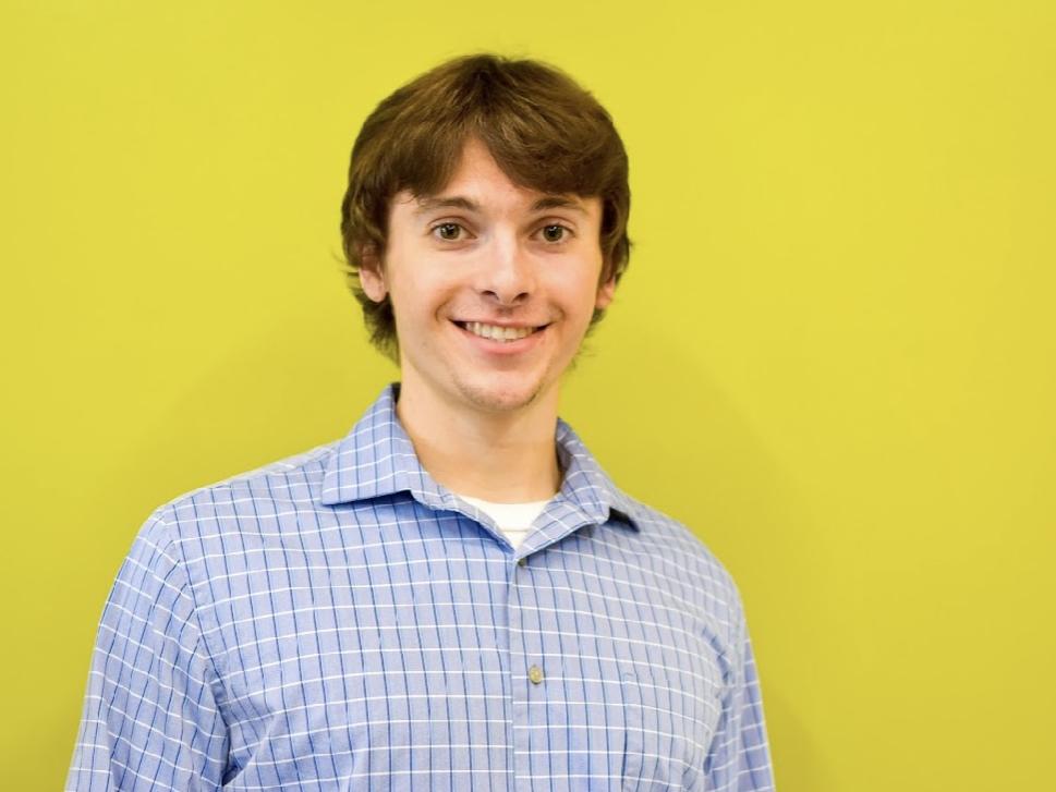 Man standing in front of bright yellow background