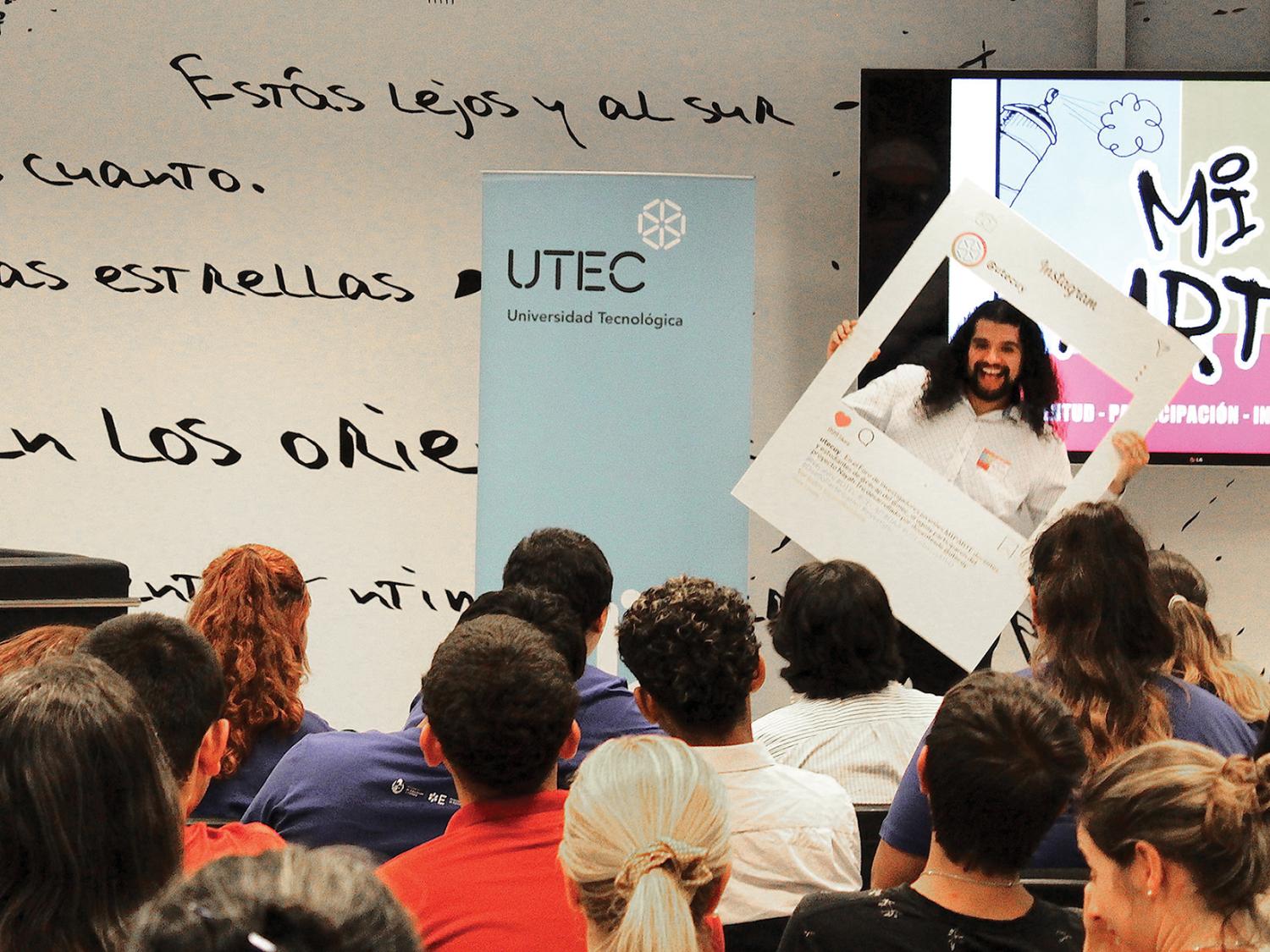 Ricardo Martinez addresses a room of students in Uruguay.