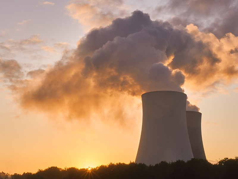 silhouette of a nuclear power plant at sunset
