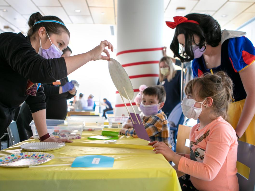 People gathered around a table making a craft