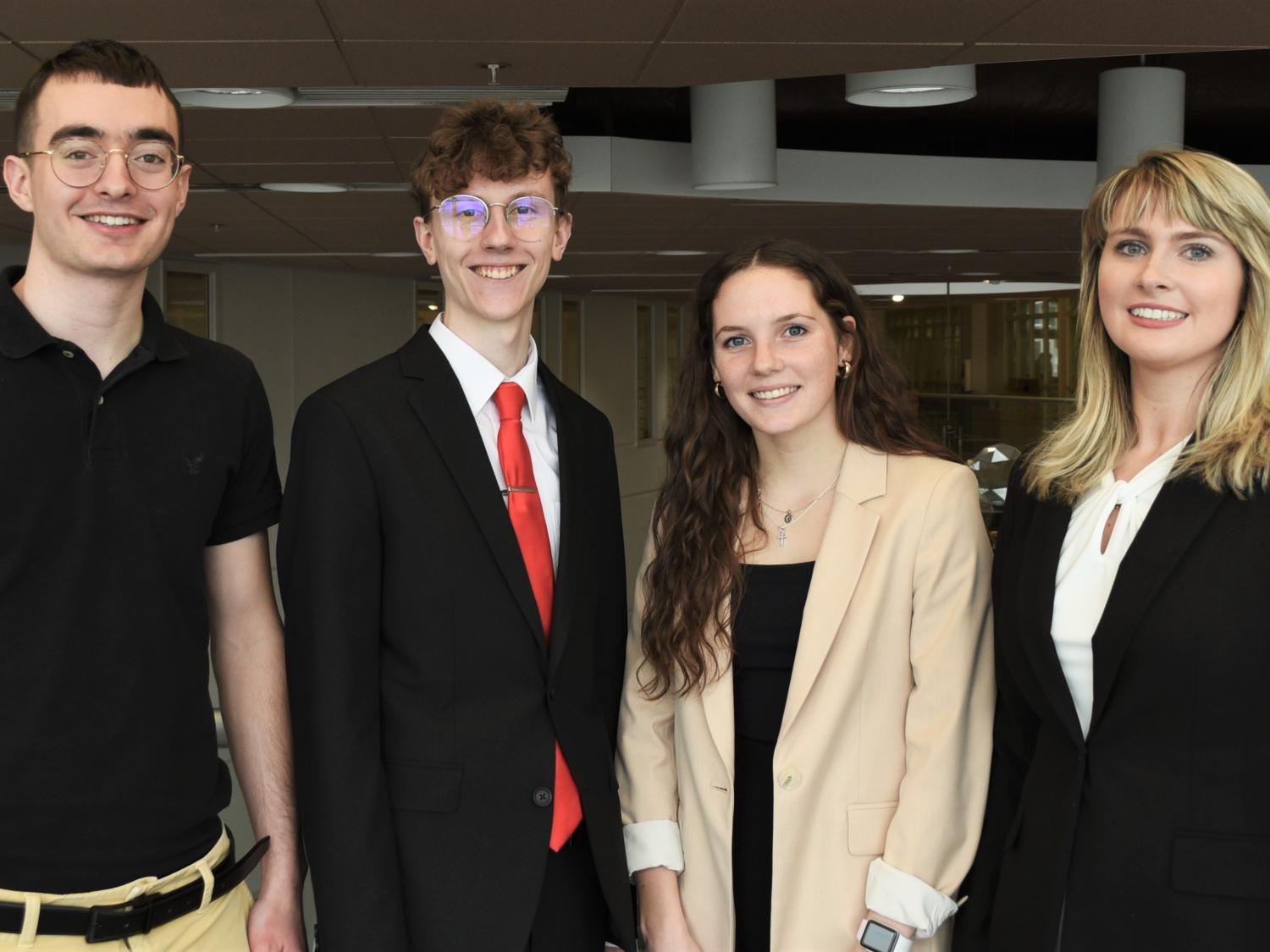 Four members of the Penn State Behrend CFA Institute Research Challenge team pose in Burke Center.
