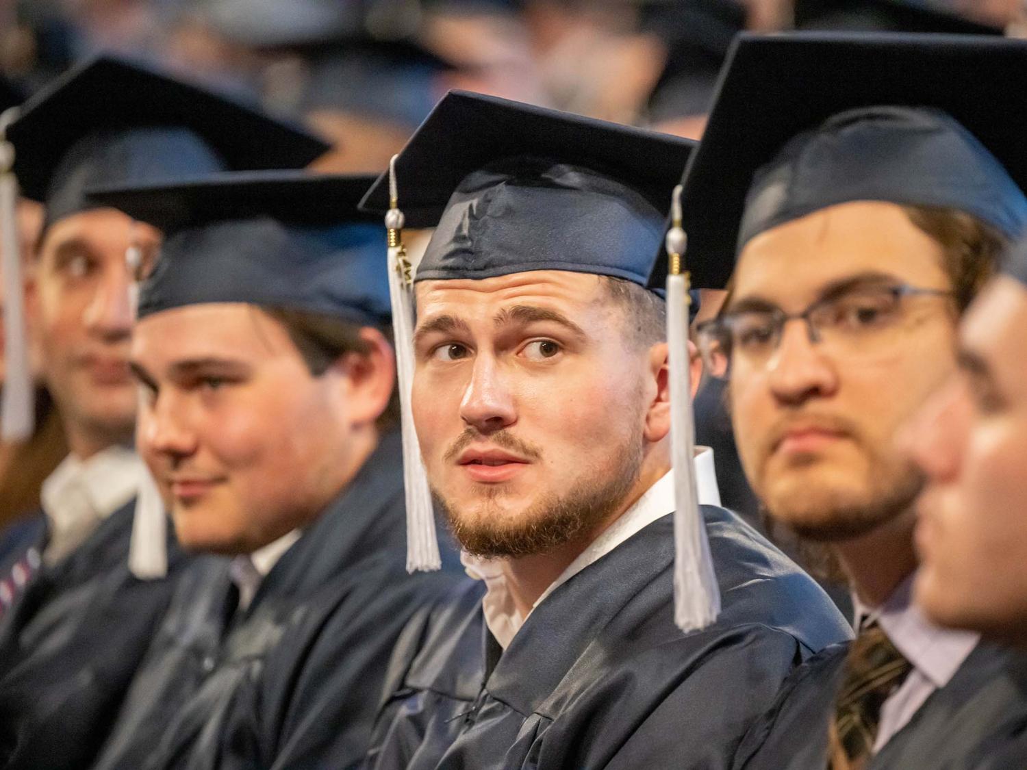 Students sit in a row during Penn State Behrend's spring commencement ceremony.