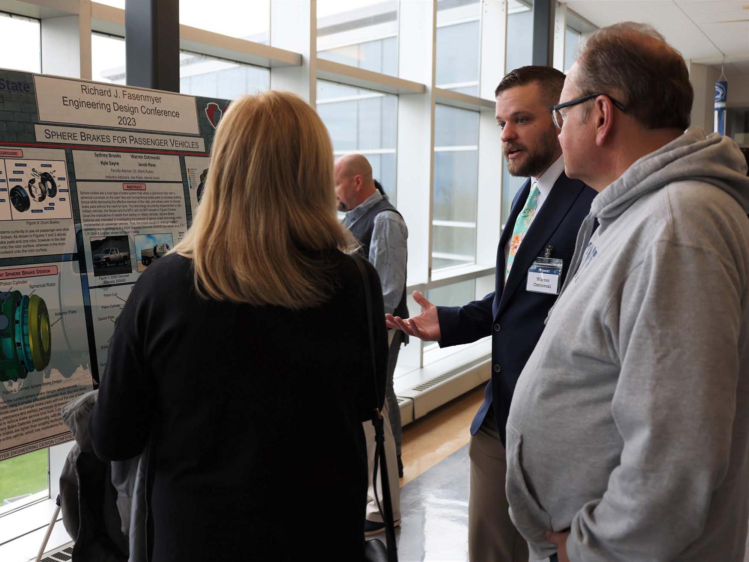 A student explains his capstone engineering project to visitors at Penn State Behrend's Fasenmyer Engineering Design Conference.